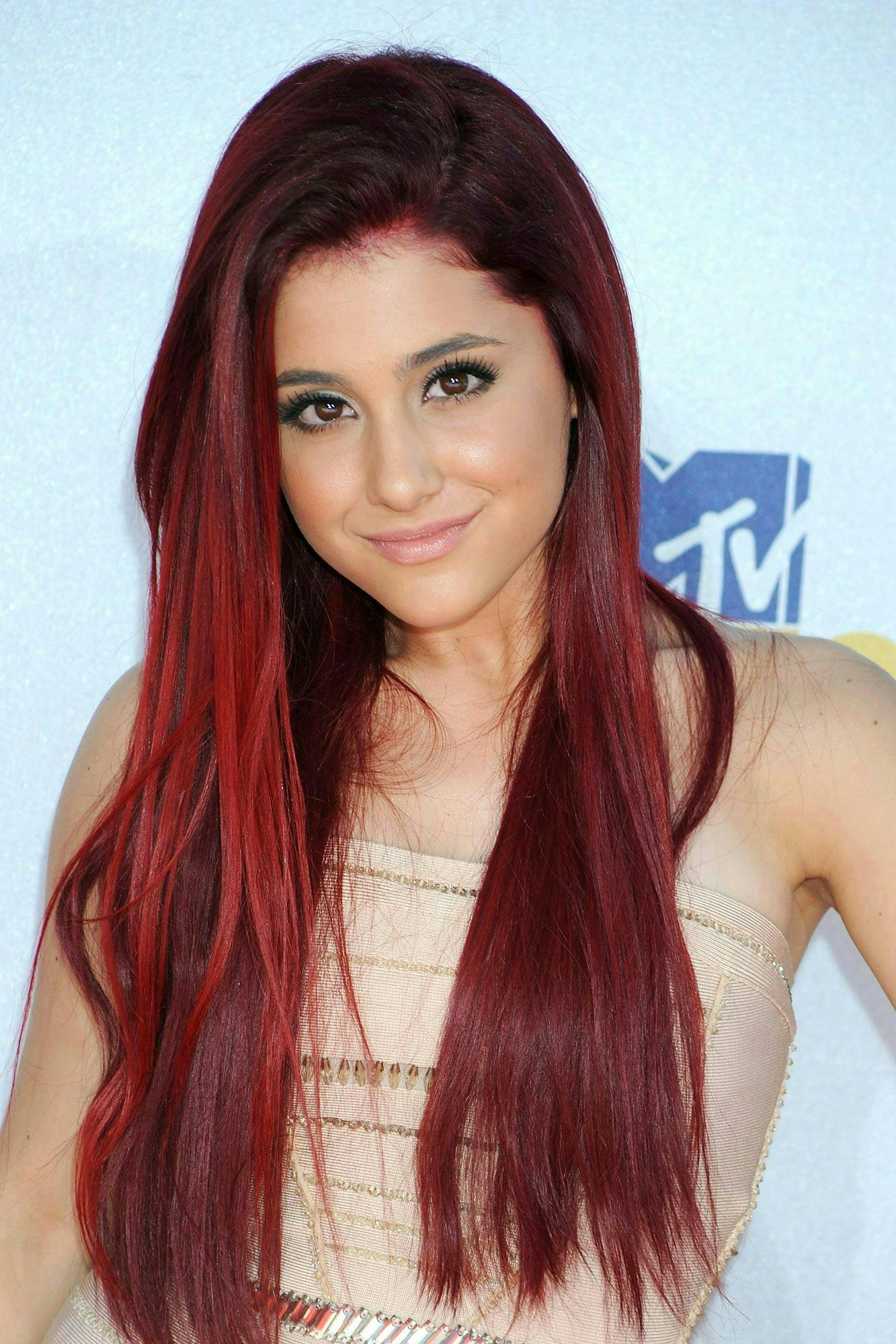 Ariana Grande with bright red hair.