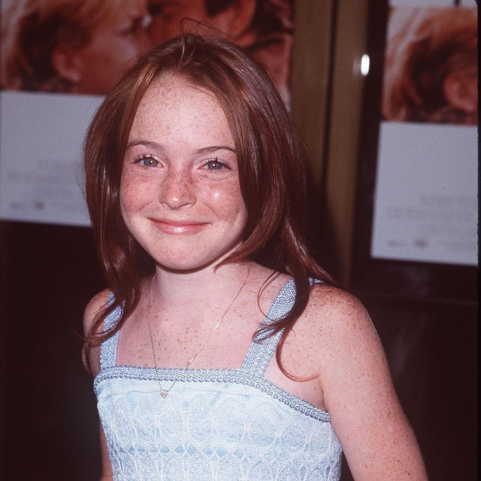 Young Lindsay Lohan posing for a photo.