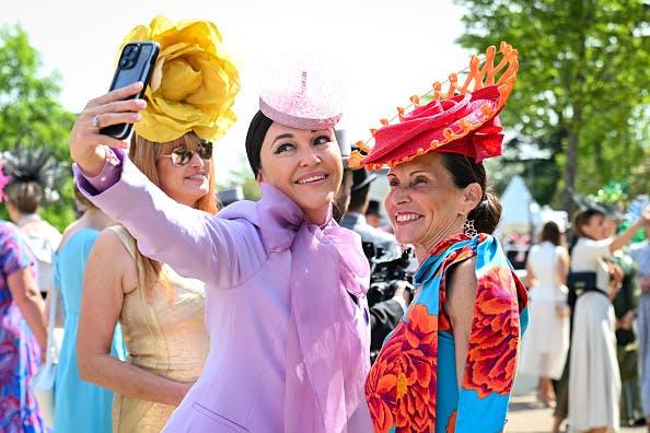 Guests in colorful hats and patterned dresses attend the 1st day of the 2024 Royal Ascot at Ascot Racecourse. Getty Images.