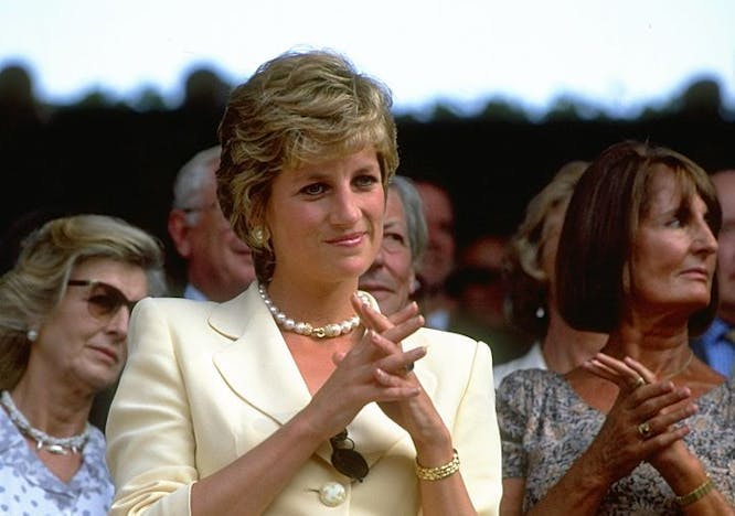 Portrait of Diana, Princess of Wales during the Lawn Tennis Championships at Wimbledon in 1995 in a yellow suit. Getty Images.